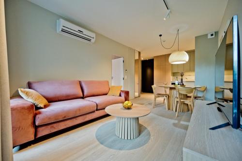 a living room with a couch and a table at Apartamenty Wydma & Las BlueApart in Jastarnia