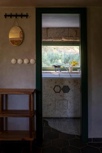a bathroom doorway with a sink and a window at ENJOY Cozy Romance Hills Forest Gardens Views Sauna Whirlpool Bath in Jablonné v Podještědí