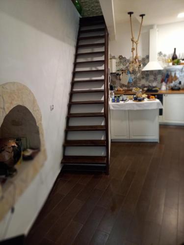 a kitchen with a spiral staircase in a room at Borgo Fontana B&B in Bari