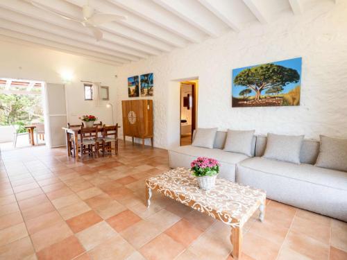 a living room with a couch and a table at Casa Piedra in Cala Saona