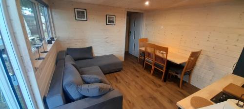 a living room with a couch and a table at Wakacyjny dom in Karwia