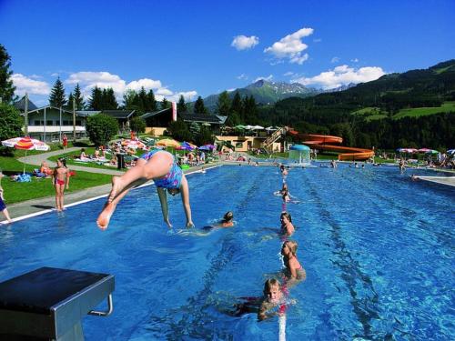 a group of people in a swimming pool at 9 persons apartment Haus Jens in Niedernsill