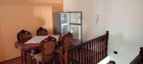 a dining room with a table and a refrigerator at Vila Tahiri in Golem
