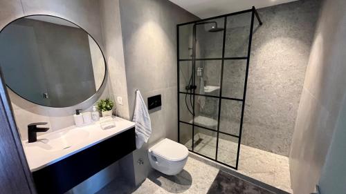 a bathroom with a shower and a sink and a mirror at Cozy flat - Casa port & Sea view in Casablanca