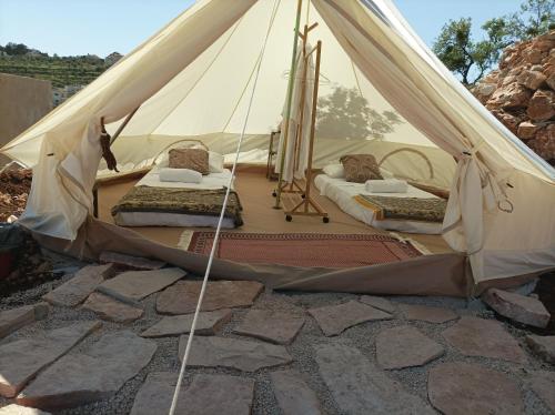 a canvas tent with two beds in it at Barrieh in Rammūn
