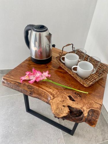 a wooden table with a tea kettle and cups on it at Relais PINF in Malcesine