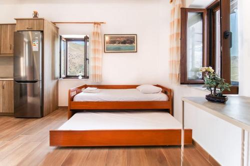 a kitchen with two bunk beds and a refrigerator at Stone house with Amazing View in Kótronas