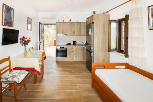 a kitchen with two beds and a table in a room at Stone house with Amazing View in Kótronas