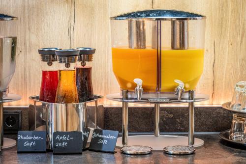 a counter with three different types of juice at AKZENT Hotel Villa Saxer in Goslar