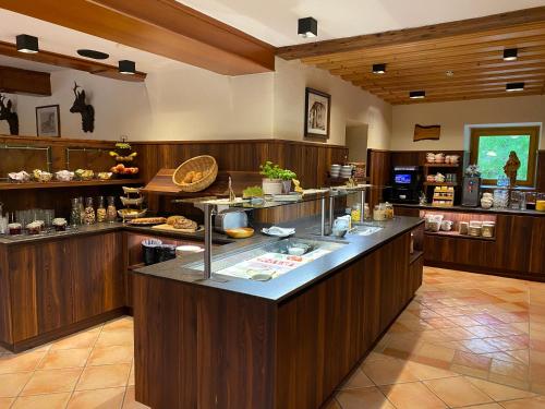 a large kitchen with a large island in a restaurant at Hotel Starchlhof in Schladming