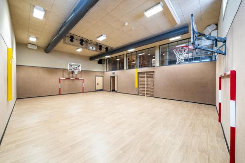 a gymnasium with a basketball hoop and a basketball court at Heidi-Hotel Falkertsee - Kinderhotel in Patergassen