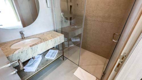 a bathroom with a sink and a shower at Hotel Pima Budva in Budva