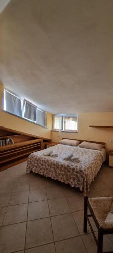 a bedroom with a bed and two windows at Villa Naclerio in Sarzana