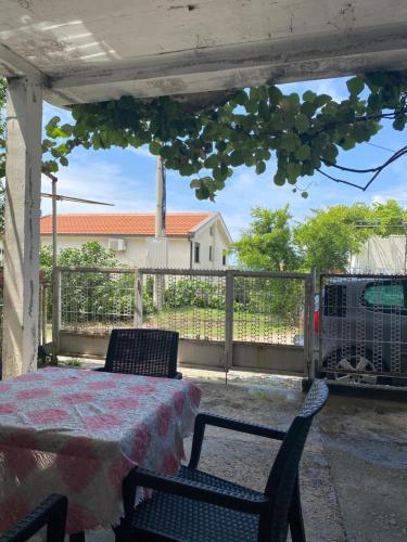 a patio with a table and chairs and a fence at Victory Apartments in Sutomore