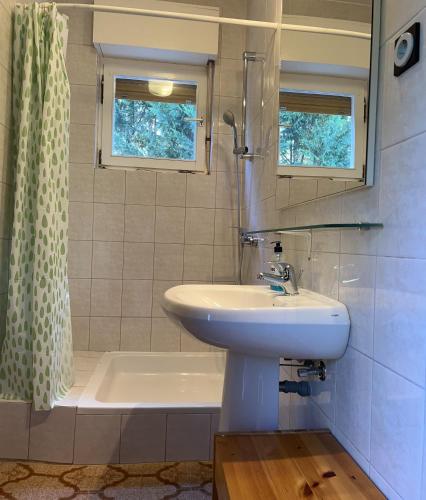 a bathroom with a sink and a tub and a shower at Apartment Sersic in Baška