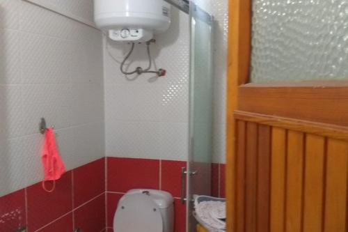 a small bathroom with a toilet in a room at Near the ladies beach only 200m in Kuşadası