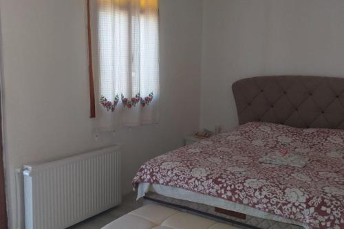 a bedroom with a bed and a window at Near the ladies beach only 200m in Kuşadası