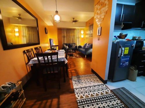 a kitchen and living room with a table and a refrigerator at Spacious 2BR condo in Araneta Cubao in Manila
