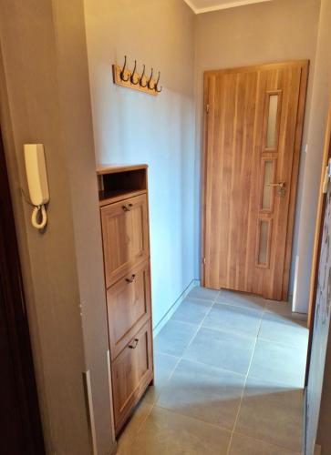 a room with a door and a cabinet and a hallway at Parkowy - Sweet House in Świnoujście