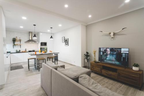 a living room with a couch and a flat screen tv at Best Houses 80 - Peace House in Ferrel