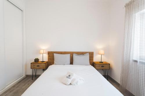a bedroom with a large white bed with two night stands at Best Houses 80 - Peace House in Ferrel