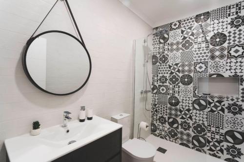 a bathroom with a sink and a mirror and a toilet at Best Houses 80 - Peace House in Ferrel