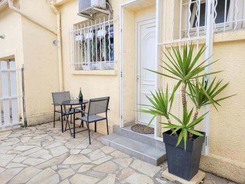 a patio with a table and chairs and a plant at Chambre climatisée 2 lits - Proche Centre Tramway in Montpellier