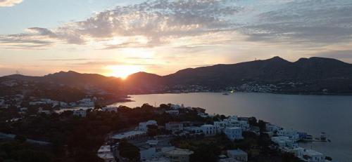 a view of a city and a lake at sunset at Panorama Appartment in Agia Marina