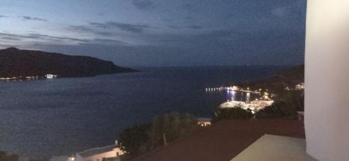 a view of a body of water at night at Panorama Appartment in Agia Marina