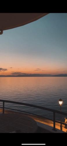 a view of the ocean at sunset from a boat at BLUE CAVE LUXURY MAISONETTE View to the Corinthian Sea in Xylokastron