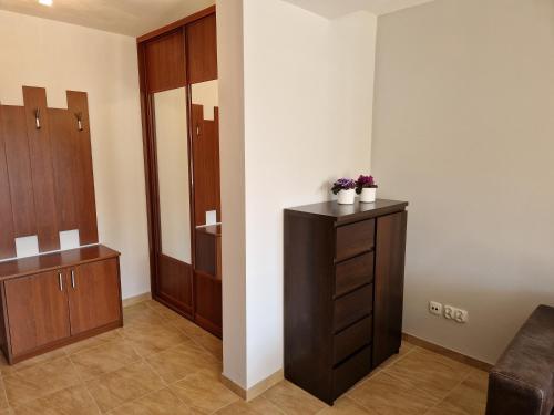 a bathroom with a vanity and a dressing room at Komfortowy Apartament w Blue Mare in Łukęcin