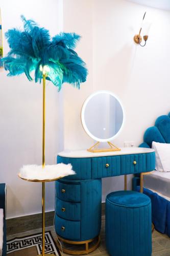 a blue dressing table with a mirror and a blue chair at Huong Mai Hotel in Da Lat