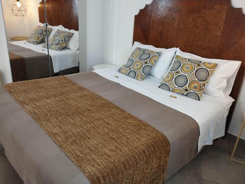 a bedroom with two beds and a mirror at Anita & Garibaldi in Marsala