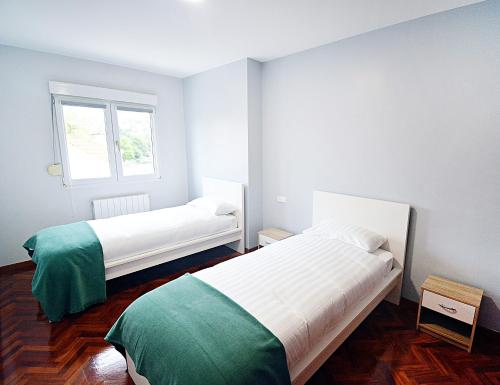 Posteľ alebo postele v izbe v ubytovaní Apartamento en Fefiñanes, Cambados