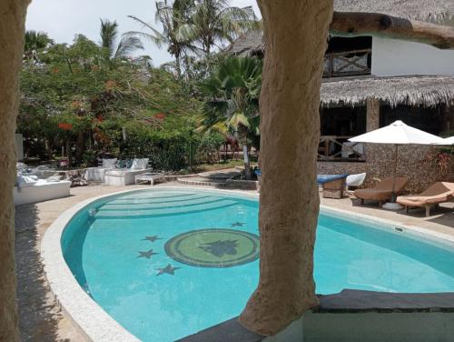 a swimming pool in the middle of a resort at Boutique Hotel Nyumbani Tembo in Watamu