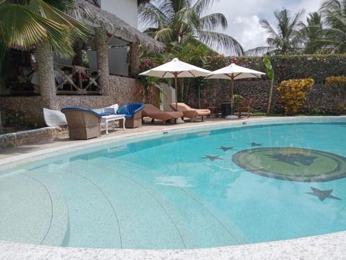 a swimming pool with stars in the water at Boutique Hotel Nyumbani Tembo in Watamu