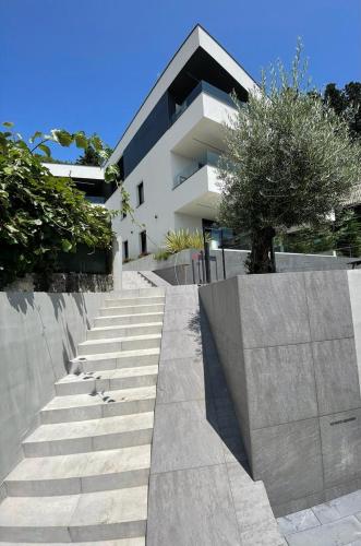 a building with stairs in front of a building at Aparthotel Villa V with breakfast and free parking in Rijeka