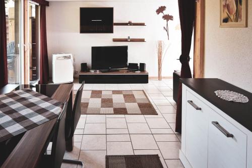 a kitchen with a television and a counter top at ferienhaus-am-scharmützelsee in Wendisch Rietz
