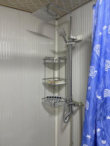 een douche in een badkamer met een douchegordijn bij Paradise Turkistan in Türkistan