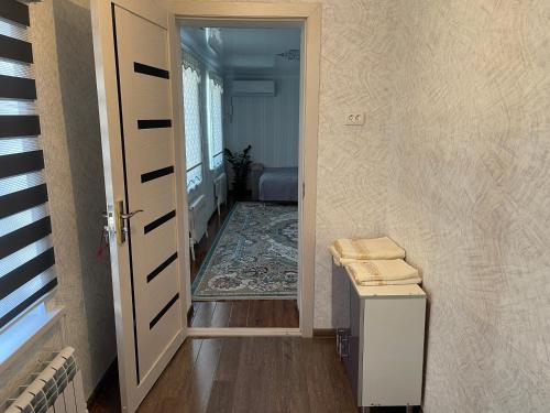 a hallway with a door open to a room at Paradise Turkistan in Türkistan