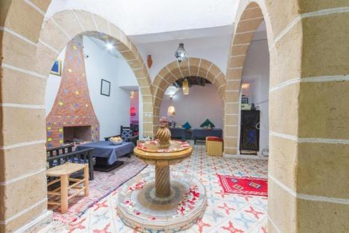 a living room with a christmas tree and a fireplace at Riad AYLAL in Essaouira