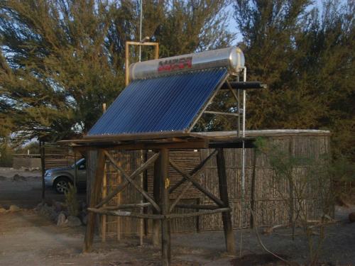 a solar powered bird house with a blue roof at El Huarango Eco Lodge in La Huaica