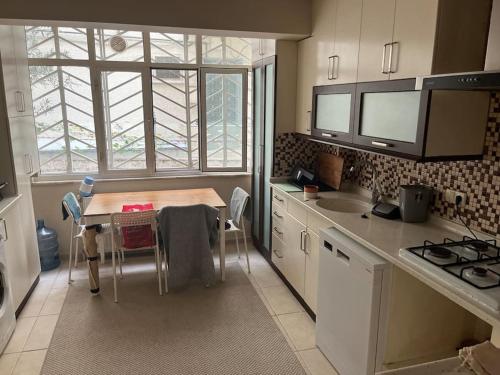 a small kitchen with a table and a sink at 250 m walking distance to metro in Burunabat