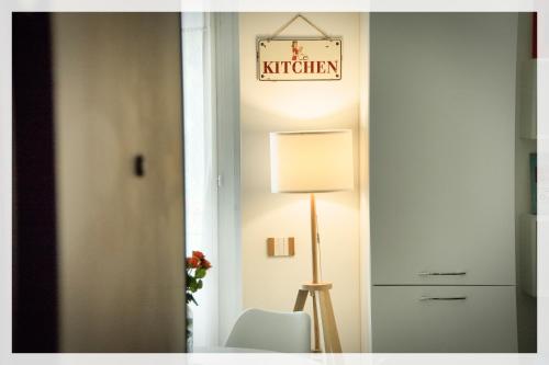 a room with a chair and a sign that reads kitchen at Your Place By The Lake - near Leonardo Academy, MXP in Sesto Calende