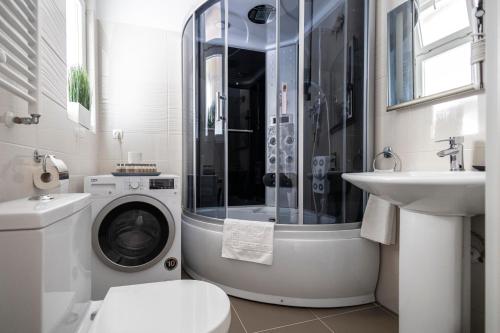Un baño con lavadora y lavabo. en Chameleon Apartment Budapest, en Budapest