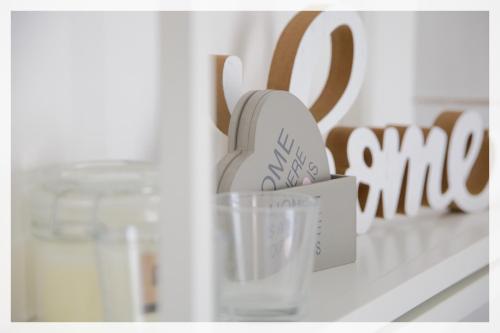 a shelf with a cup and a glass on it at Your Place By The Lake - near Leonardo Academy, MXP in Sesto Calende
