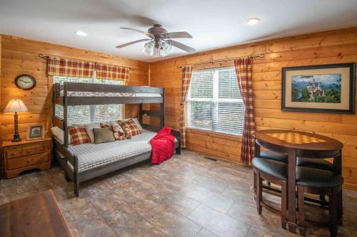 a bedroom with a bunk bed and a table at Moss Haven Cabin - Peaceful Blowing Rock Getaway in Blowing Rock