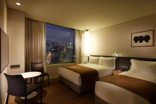 a hotel room with two beds and a window at Shilla Stay Seodaemun Seoul Station in Seoul