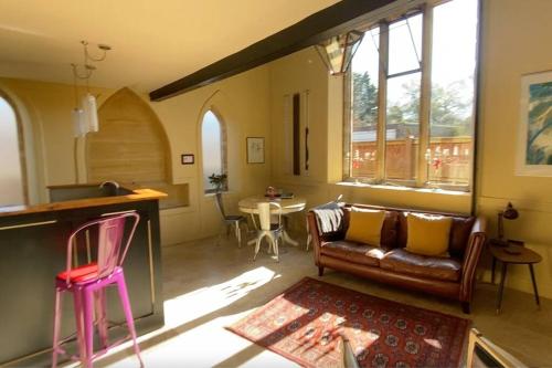 a living room with a couch and a table at The Sunday Schoolroom in Sherborne