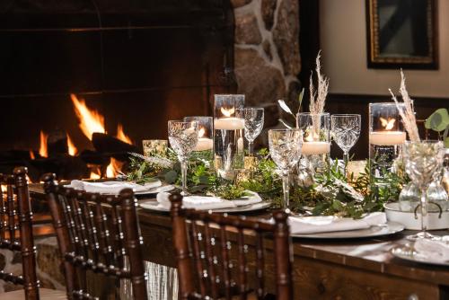 a table with candles and flowers and a fireplace at Christmas Farm Inn and Spa in Jackson